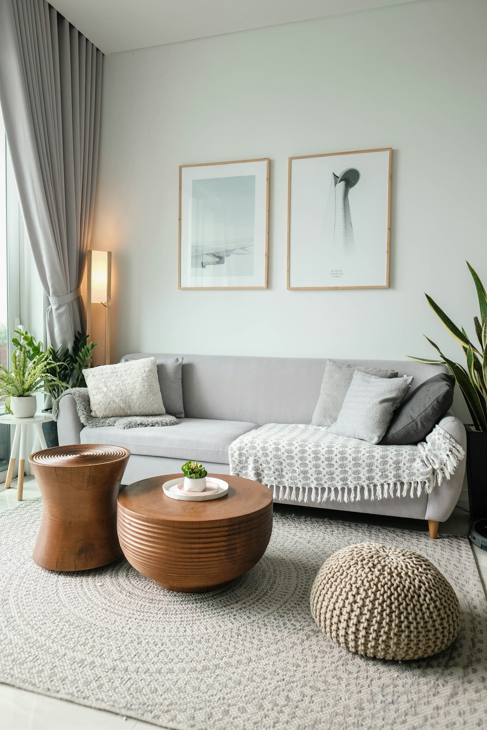 A designer living room with curved velvet sofa, arched doorway, rounded coffee table, and soft organic silhouettes