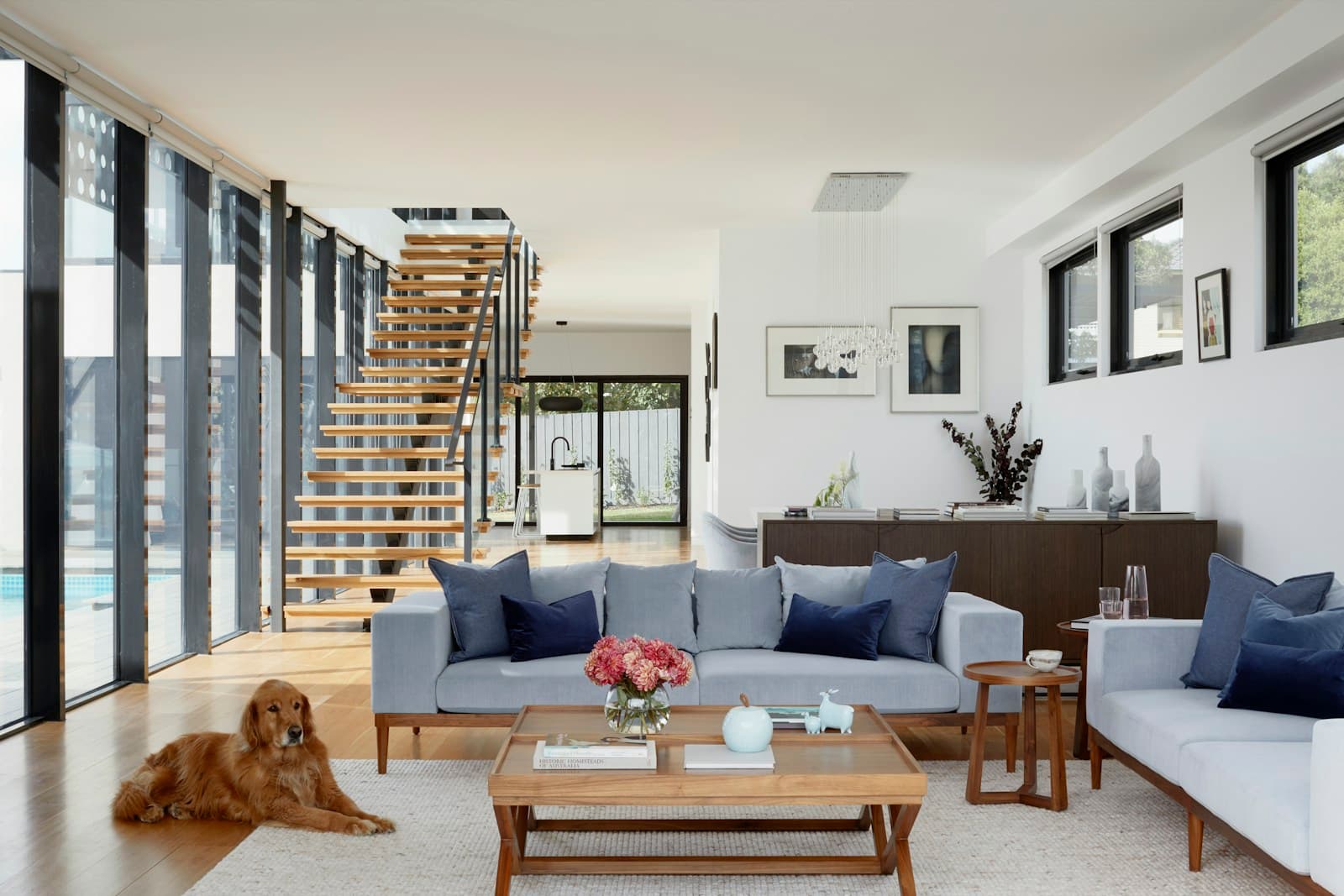 A warmly lit interior featuring reclaimed wood shelving, natural stone surfaces, handwoven textiles, and organic pottery